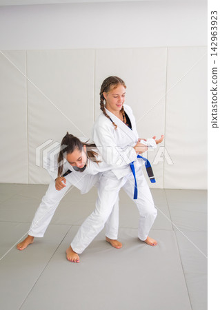 Jiu jitsu student practicing a waki gatame armlock Jiu jitsu student practicing a waki gatame armlock 142963923