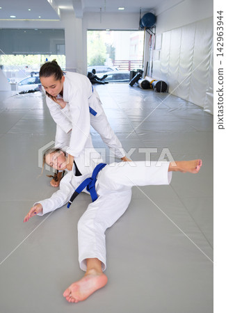Ko-uchi-gari throw finish during martial arts training Ko-uchi-gari throw finish during martial arts training 142963944