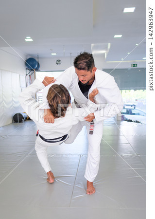 Black belt partners entering an uchi-mata throw in BJJ Black belt partners entering an uchi-mata throw in BJJ 142963947