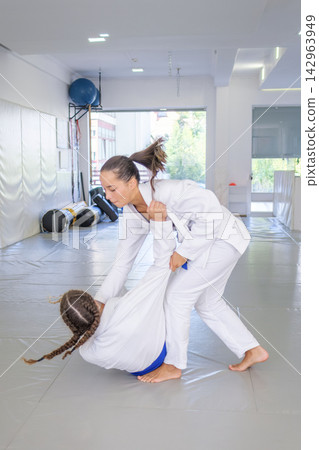 Uchi-mata landing by female Brazilian jiu jitsu athletes Uchi-mata landing by female Brazilian jiu jitsu athletes 142963949