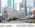 The Shinbashi Station building and the cluster of high-rise buildings in Shiodome in the background: an urban landscape. 142963964