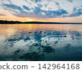 Sunset reflects on calm water 142964168