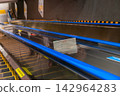 Escalator handrails and warning signs: Image of safety management for the facility. 142964283