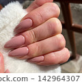 Perfect almond-shaped manicure in a soft pastel pink color. 142964307