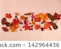 Vibrant, beautiful banner and Hello Autumn greeting card. Abstract autumn composition featuring maple leaves, pine cones, nuts, cinnamon, star anise, dried orange slices, and rowan berries 142964436