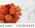 Seasonal banner featuring maple leaves and pumpkins Thanksgiving themed still life or website header, abstract autumn composition for greeting card or invitation with copy space, 142964449
