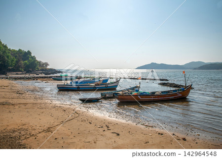 Fishermen - a man and a woman, mother and son, unravel the polluted fishing net and smile, prepare the net for the next fishing Fishermen - a man and a woman, mother and son, unravel the polluted fishing net and smile, prepare the net for the next fishing 142964548