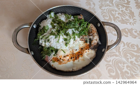 Homemade breakfast with white rice canned sardines and fried eggs served in a pan Homemade breakfast with white rice canned sardines and fried eggs served in a pan 142964964