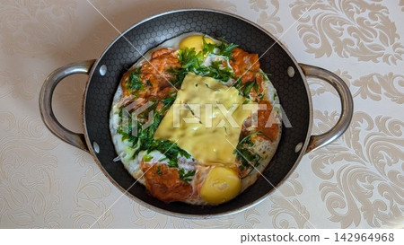 Homemade pan breakfast with fried eggs melted cheese and tomato soaked bread Homemade pan breakfast with fried eggs melted cheese and tomato soaked bread 142964968