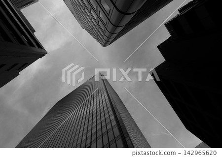 The dynamic, geometric, monochrome architectural beauty of the skyscrapers viewed from directly below. The dynamic, geometric, monochrome architectural beauty of the skyscrapers viewed from directly below. 142965620