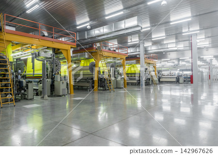 Modern Textile Factory Interior with Industrial Weaving Machines Modern Textile Factory Interior with Industrial Weaving Machines 142967626