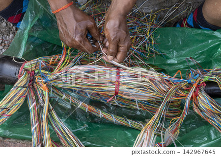 Telecom Technician Hands Repairing Colorful Fiber Optic Cables 142967645