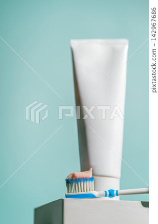 A toothbrush with a dab of pink toothpaste A toothbrush with a dab of pink toothpaste 142967686