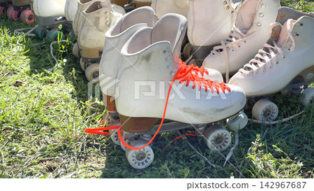 Roller skates rental retro sports background. Quad skating boots outdoor grass activity. Fun summer hobby active lifestyle backdrop. Roller skates rental retro sports background. Quad skating boots outdoor grass activity. Fun summer hobby active lifestyle backdrop. 142967687