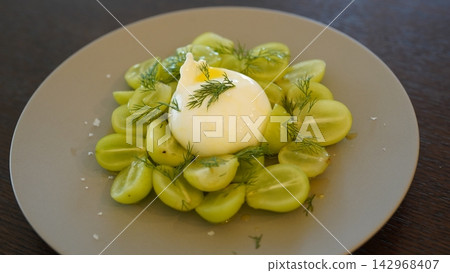 Caprese salad with Shine Muscat grapes and burrata cheese served on a gray plate. Caprese salad with Shine Muscat grapes and burrata cheese served on a gray plate. 142968407