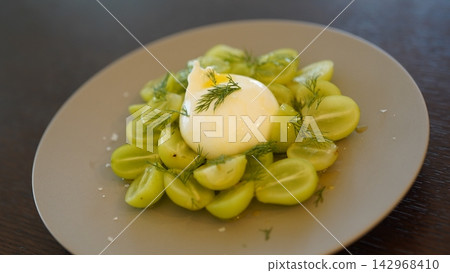 Caprese salad with Shine Muscat grapes and burrata cheese served on a gray plate. Caprese salad with Shine Muscat grapes and burrata cheese served on a gray plate. 142968410