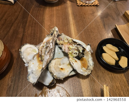 Grilled oysters from Hokkaido, cooked to perfection. Grilled oysters from Hokkaido, cooked to perfection. 142968558