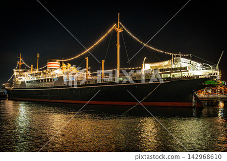 The Ocean Liner Hikawa Maru shines brightly in the nostalgic night view of Yokohama. The Ocean Liner Hikawa Maru shines brightly in the nostalgic night view of Yokohama. 142968610
