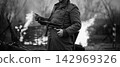 German Wehrmacht Infantry Soldier In World War Ii Standing Against The Background Of A Burning House. German WWII Soldier 142969326