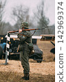WWII portraying a German Feldgendarmerie soldier carries a rifle with fixed bayonet while guarding a military checkpoint on the Eastern Front. WWII portraying a German Feldgendarmerie soldier carries a rifle with fixed bayonet while guarding a military checkpoint on the Eastern Front. 142969374