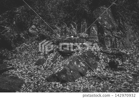 A group of stone Buddha statues depicted in monochrome. A group of stone Buddha statues depicted in monochrome. 142970932