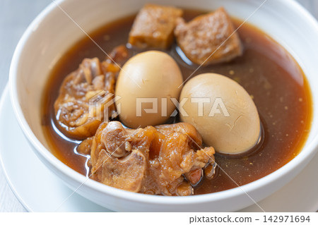 Braised chicken and egg soup in white bowl with tofu and dark broth Braised chicken and egg soup in white bowl with tofu and dark broth 142971694