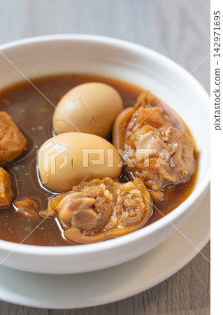 Braised egg and pork dish in dark savory broth with tender meat and warm comfort 142971695