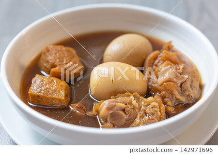 Braised egg and tofu stew in savory brown broth with tender meat Braised egg and tofu stew in savory brown broth with tender meat 142971696