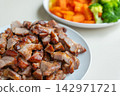 Roasted pork with carrot and broccoli on plate, tender and flavorful 142971721
