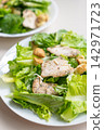 Grilled chicken lettuce salad with crouton and mushroom served on plate 142971723