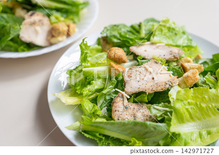 Chicken salad with romaine lettuce, crouton, and cheese Chicken salad with romaine lettuce, crouton, and cheese 142971727
