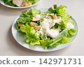 Romaine lettuce salad with creamy dressing and crouton topping 142971731