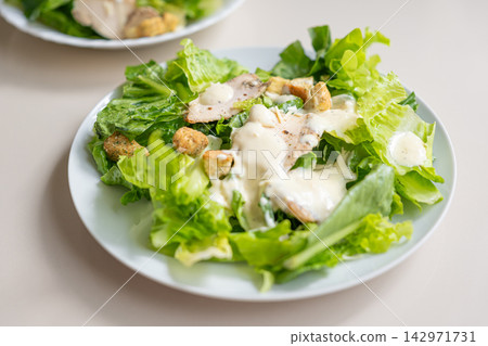 Romaine lettuce salad with creamy dressing and crouton topping 142971731