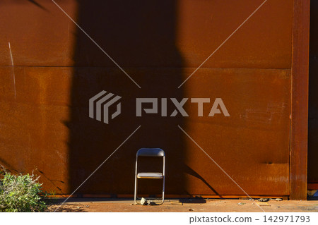 Rusty iron wall and chair Rusty iron wall and chair 142971793