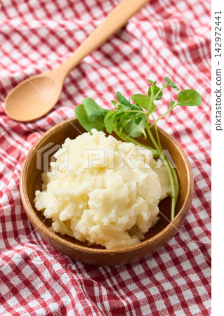 Mashed potatoes served on a wooden plate Mashed potatoes served on a wooden plate 142972441
