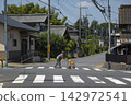 Elderly people crossing the intersection 142972541