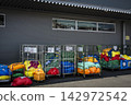 A dry cleaning factory lined with colorful bags 142972542