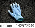 Work gloves remaining on the road surface 142972549