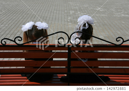 Little girls on bench Little girls on bench 142972881
