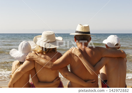 Family in hats at the beach Family in hats at the beach 142972882