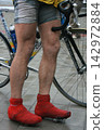 Man with bicycle in a street 142972884