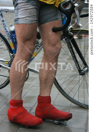 Man with bicycle in a street Man with bicycle in a street 142972884