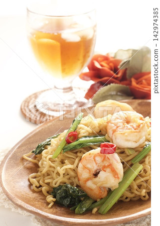 Indonesian fried noodles (Mie Goreng) and iced tea Indonesian fried noodles (Mie Goreng) and iced tea 142974385