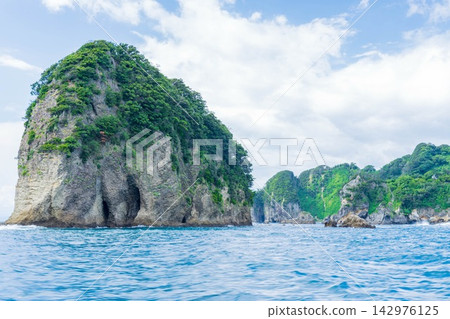 A coastline with a clear blue sea and sky stretching out before you. A coastline with a clear blue sea and sky stretching out before you. 142976125