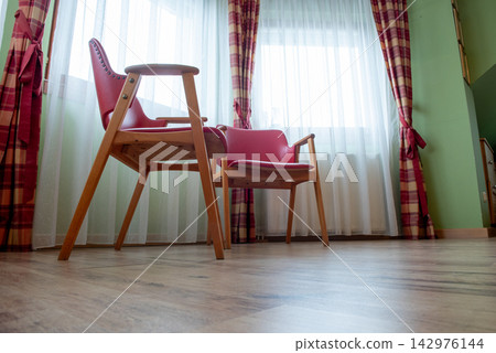 mid-century wooden armchairs with red leather upholstery by window mid-century wooden armchairs with red leather upholstery by window 142976144