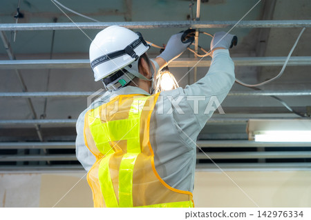 Workers working at a construction site Workers working at a construction site 142976334