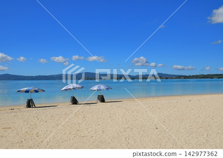 A tropical scene at Kouri Beach in Okinawa, lined with parasols. A tropical scene at Kouri Beach in Okinawa, lined with parasols. 142977362