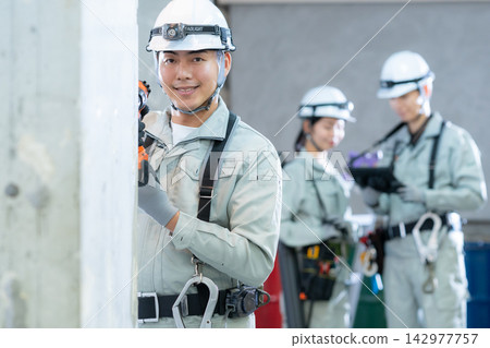 Workers working at a construction site Workers working at a construction site 142977757