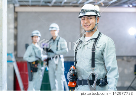 Workers working at a construction site Workers working at a construction site 142977758