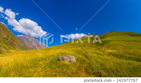 Vast Mountain Landscape with Rolling Green Hills in Kyrgyzstan Vast Mountain Landscape with Rolling Green Hills in Kyrgyzstan 142977787